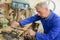 Senior craftsman working in shed