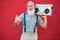 Senior crazy man with 80`s boombox stereo playing rock music with red background - Trendy mature guy having fun dancing with