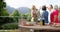 Senior diverse group enjoys a meal outdoors, with copy space