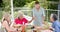 Senior diverse group of women enjoy a meal outdoors