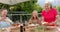 Senior diverse group of women enjoy a meal outdoors