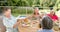 Senior diverse group of women enjoy a meal outdoors