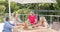 Senior diverse group of women enjoy a meal outdoors, with copy space