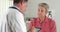 Senior doctor asking elderly patient questions