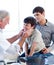 Senior doctor examining little boy\'s throat