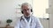 Senior doctor wears headset makes distant video call, webcam view