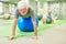 Senior does physiotherapy on exercise ball