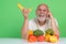 Senior drink near fruits and vegetables in studio. Elderly man on fruits and vegetables diet. Vegetables and Healthy