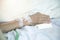 Senior elder asian patient woman in hospital eating her lunch on a tray, focus on hand with syringe  injection and plaster