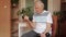 Senior elderly caucasian man doing weight lifting dumbbell exercising at home