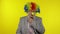 Senior elderly clown businessman entrepreneur boss in wig adjusts yellow nose
