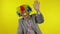 Senior elderly clown businessman entrepreneur in wig waves his hands, smiling
