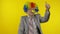Senior elderly clown businessman freelancer in wig show thumb up. Halloween