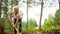 Senior elderly gardener woman digging caring ground level at summer farm countryside outdoors using garden tools rake