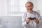 Senior elderly laughing on sofa using controller play game