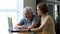 Senior elderly man grandfather and adult daughter, helping him with computer