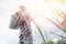 Senior elderly man with gray beard is pouring watering can in vegetable garden of plant