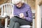 Senior elderly person keeping mind active by doing crossword puzzle