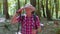 Senior elderly tourist grandfather training Nordic walking with ski trekking poles, hiking in wood