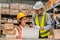 senior engineer manager supervisor working with young woman engineer staff worker in factory hardware parts store inventory room