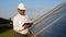 Senior engineer is working with tablet at solar station