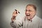 Senior excited man writing something with pen on blackboard