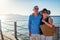 Senior family couple walking on pier by Red sea. Retired people enjoying vacation in Egypt enjoying landscape.