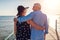 Senior family couple walking on pier by Red sea. Retired people enjoying vacation in Egypt enjoying landscape.