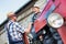 Senior farmer driving tractor while shaking hands with mature farmer