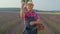 Senior farmer grandfather man in field growing purple lavender, celebrating success, winning gesture