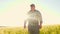 Senior farmer walking in wheat field