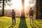 Senior father and his son standing by tree at sunset, looking at each other.