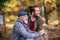 Senior father and his son on walk in nature, standing and talking.