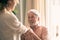 Senior father looking tenderly his daughter, spending time together at home