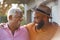 Senior Father Talking And Laughing With Adult Son In Garden At Home