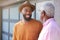 Senior Father Talking And Laughing With Adult Son In Garden At Home