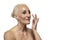 Senior Female Concepts. Portrait Nude of  Senior Caucasian Woman Using Facial Cream. Against White Background