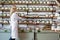 Senior female employee arranging spice jars on shelf