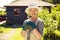 Senior female gardener in backyard with shovel