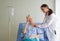 Senior female patient and doctor. The Young doctor uses a stethoscope to check the heartbeat of the elderly patients with