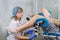 Senior female positively gynecologist examining a patient at clinic, health care concept