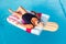 Senior female woman with bright sun glasses lies on a swimming pool inflatable icecream shaped float