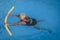 Senior female woman holds on to a flotation device on a swimming pool to learn how to swim