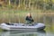 Senior fishing on lake from a small boat