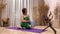 Senior fitness instructor shows Seated Twist Pose using phone indoors