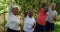 Senior friends doing exercise in garden 4k