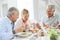 Senior friends having lunch at home