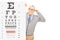 Senior gentleman with glasses standing behind eyesight test