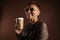 Senior ginger woman in sunglasses drinking coffee takeaway
