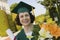 Senior Graduate holding diploma and flowers